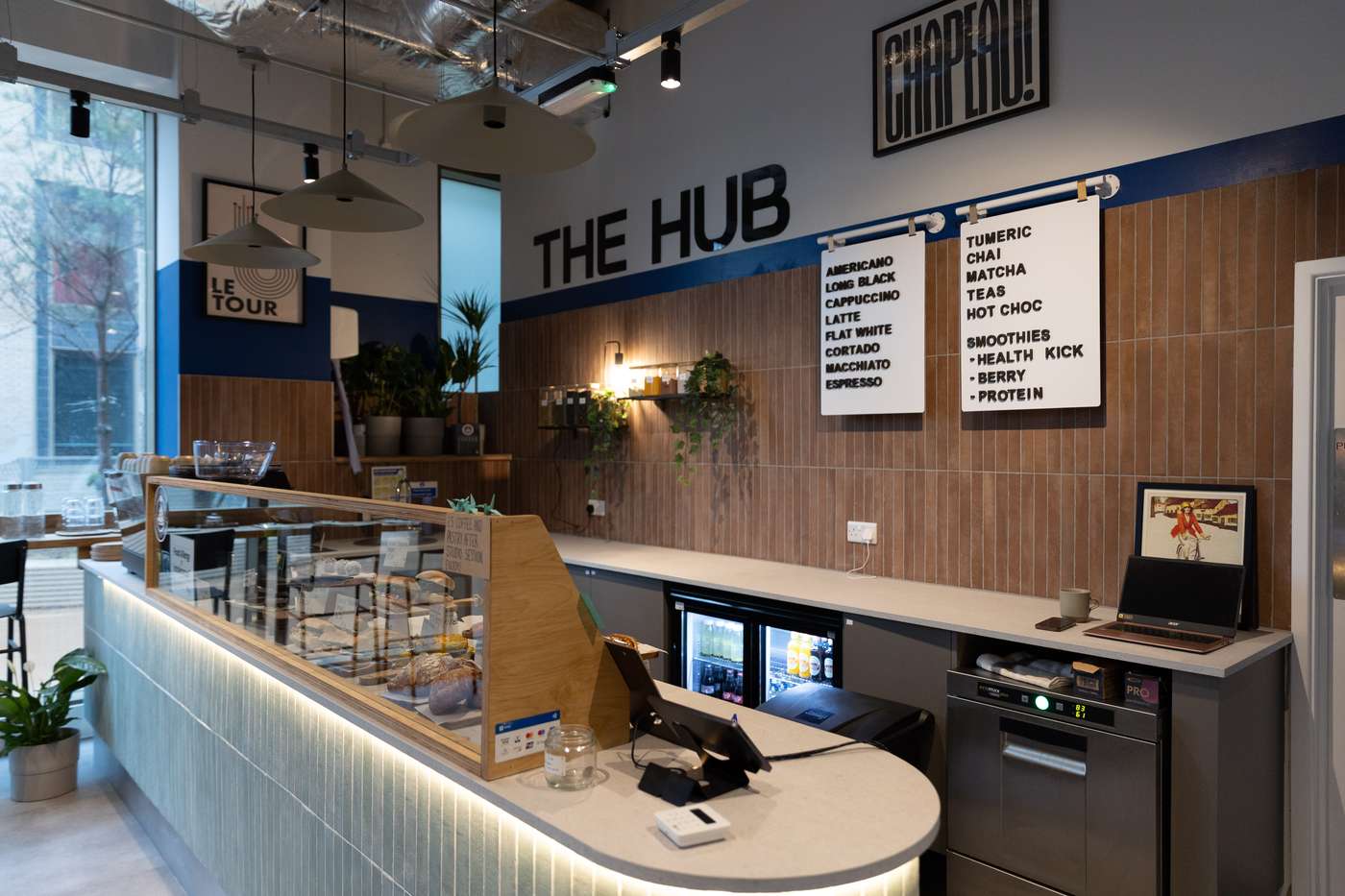The Hub cafe at PowerWatts, warm timber counter and menu boards