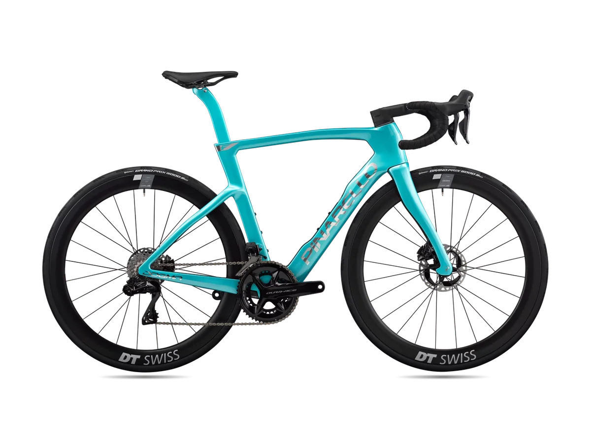 A celeste Pinarello Dogma F road bike, side view, with the points a bike fit adjusts labelled