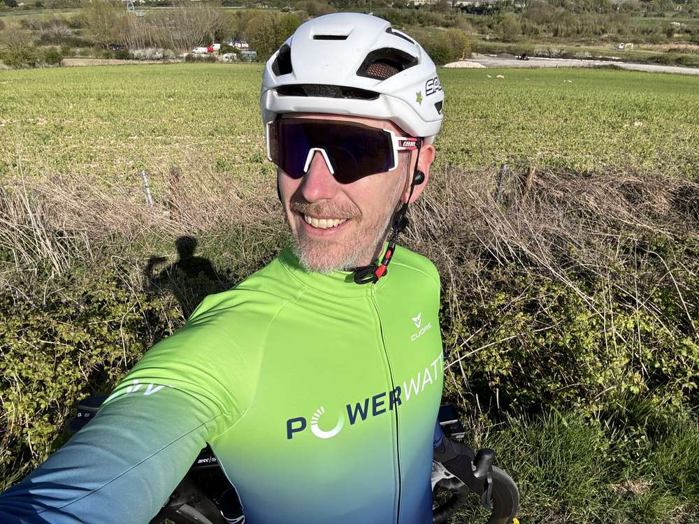A smiling rider in PowerWatts kit out on a community ride